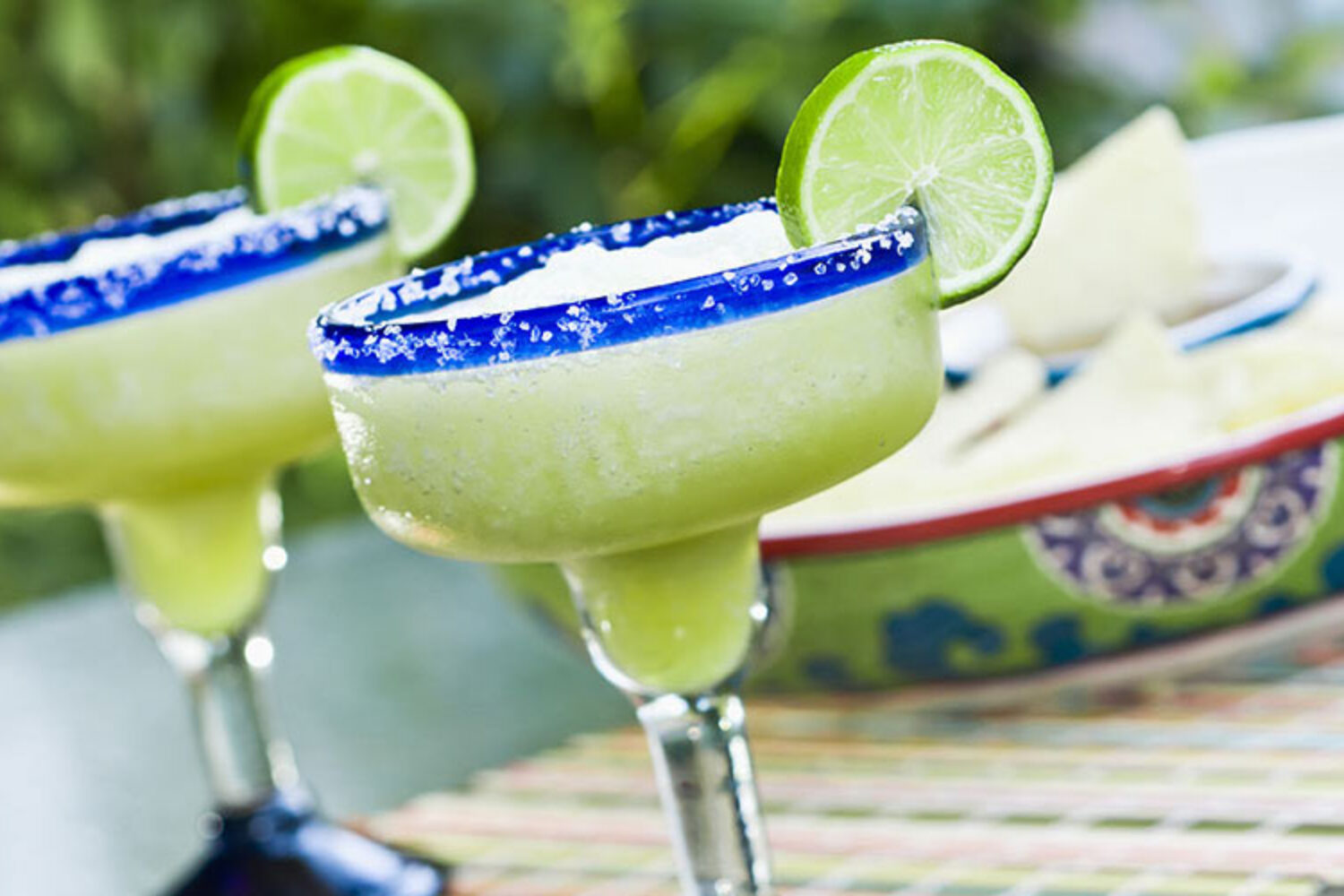 Margarita cocktail with salted rim and lime garnish.