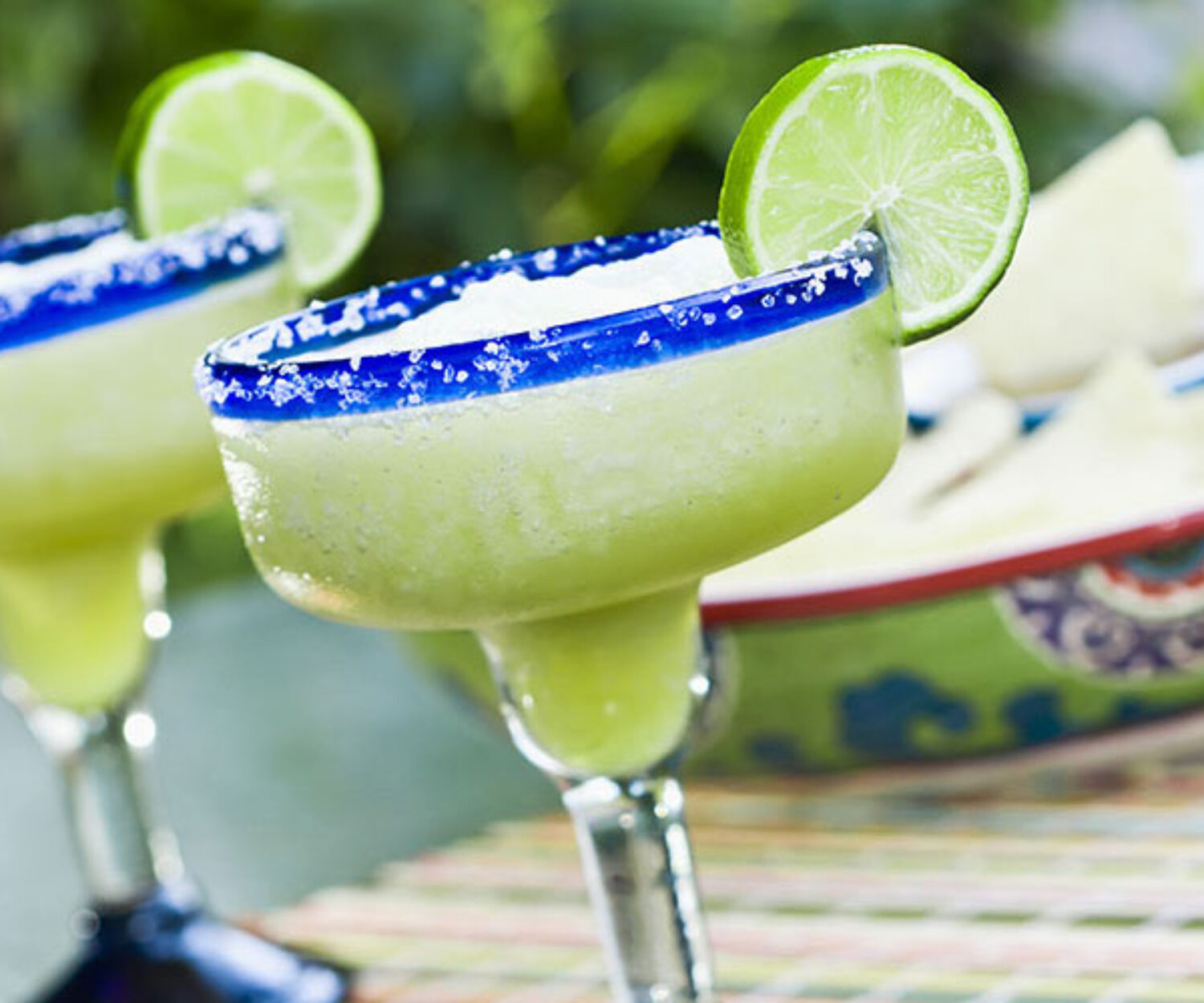 Margarita cocktail with salted rim and lime garnish.